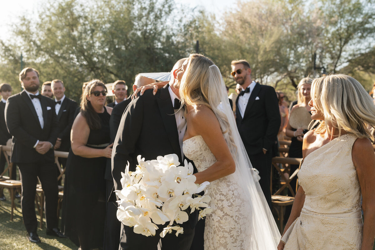 Bride hugging dad at wedding ceremony at El Chorro