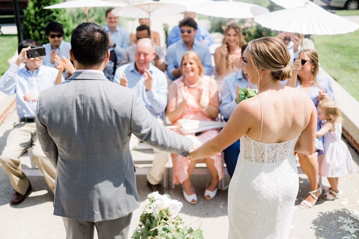 Photo of small ceremony on the steps of the Peter Shields Inn