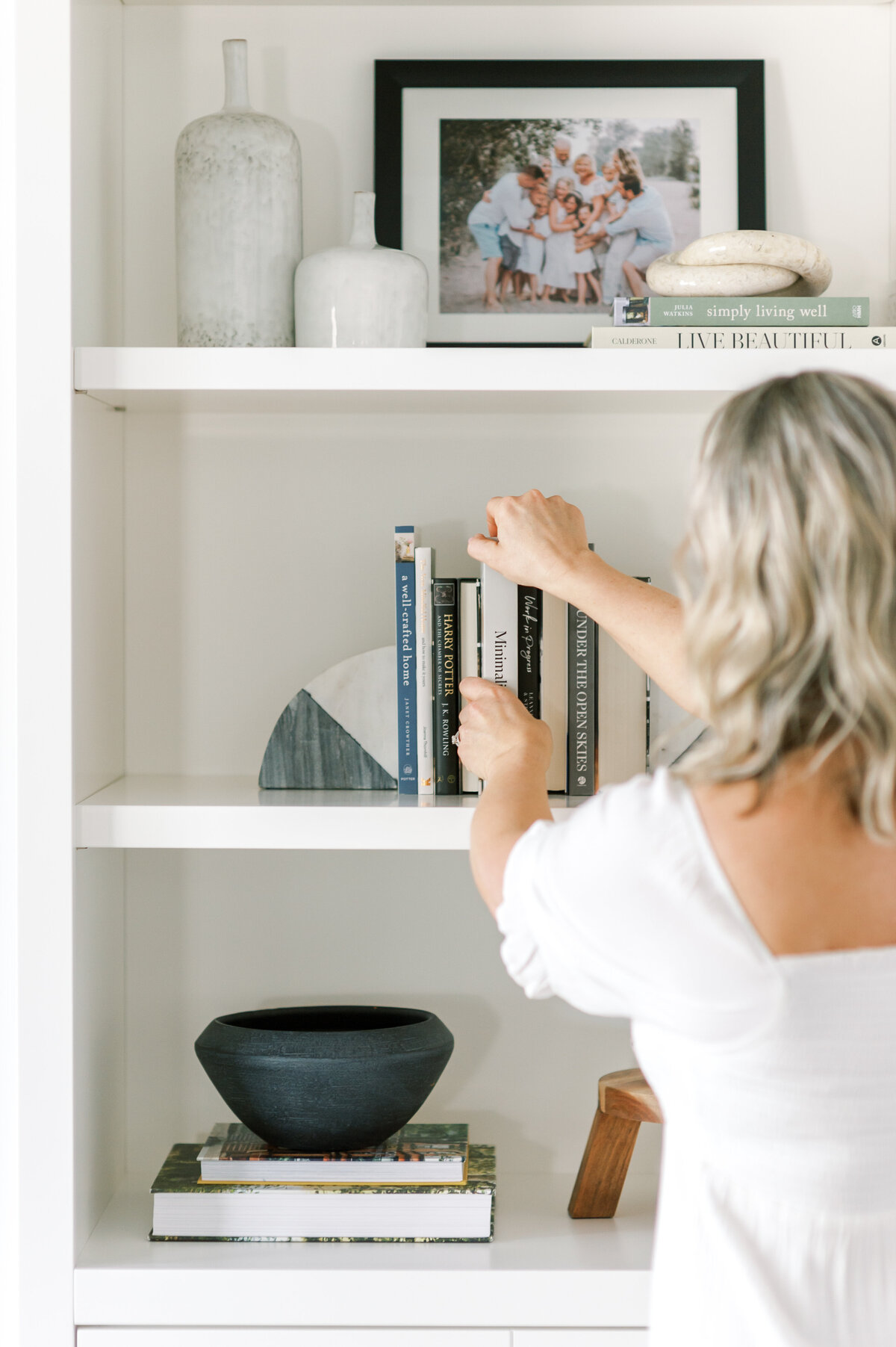Premiere Ontario, Canada Interior Designer arranged books on a styled shelf in her home.