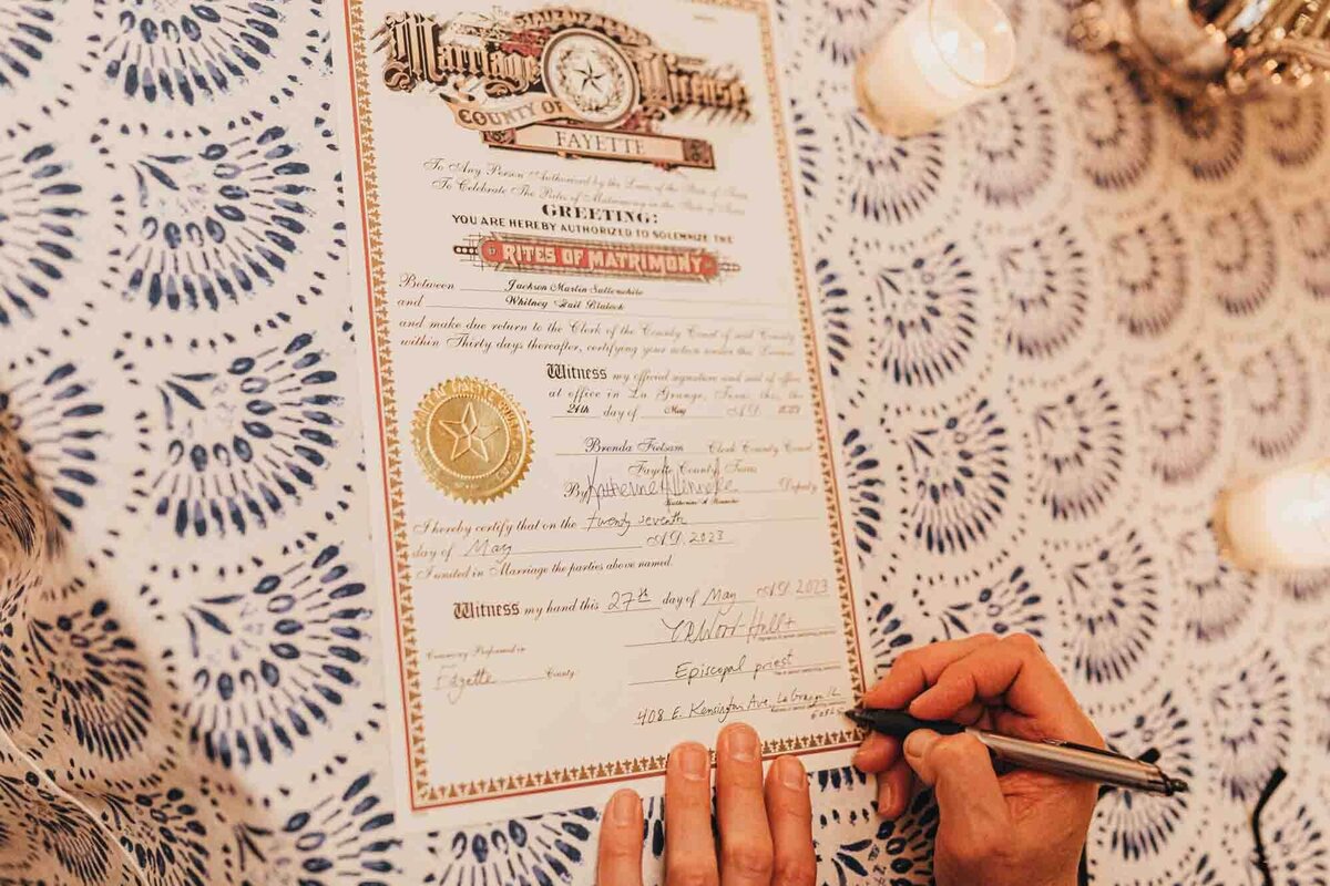 marriage license for Whitney and Jackson, on blue and white linens.