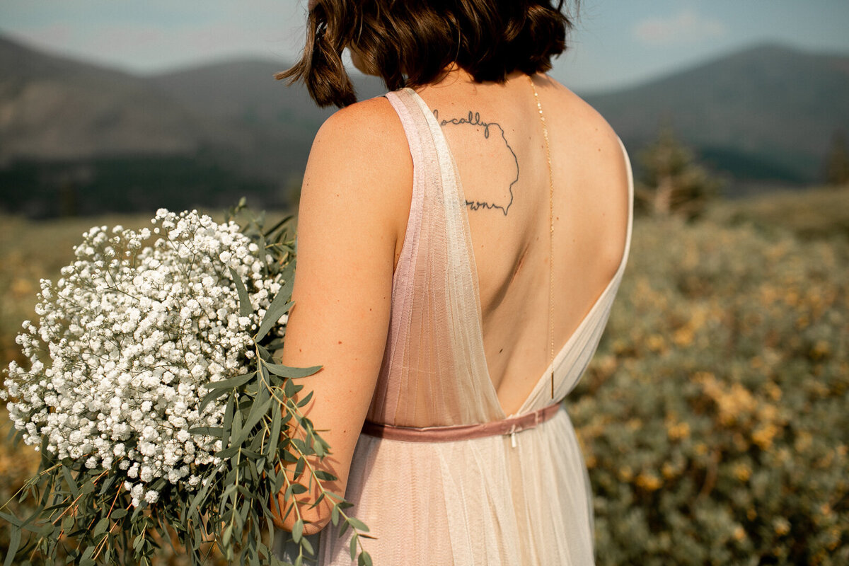 Colorado bride holding flowers in the mountains