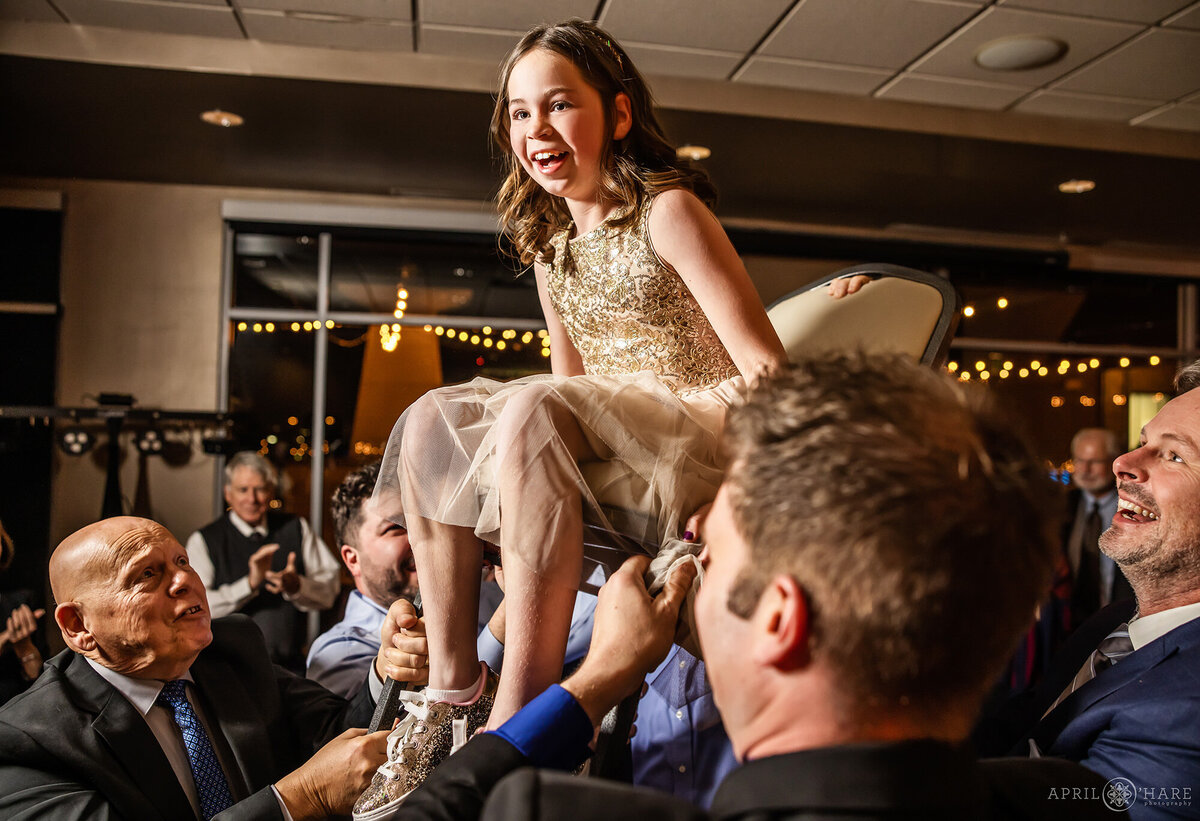 Young Girl on a Chair for the Horah Dance at her Brother's Bar Mitzvah Party in Colorado