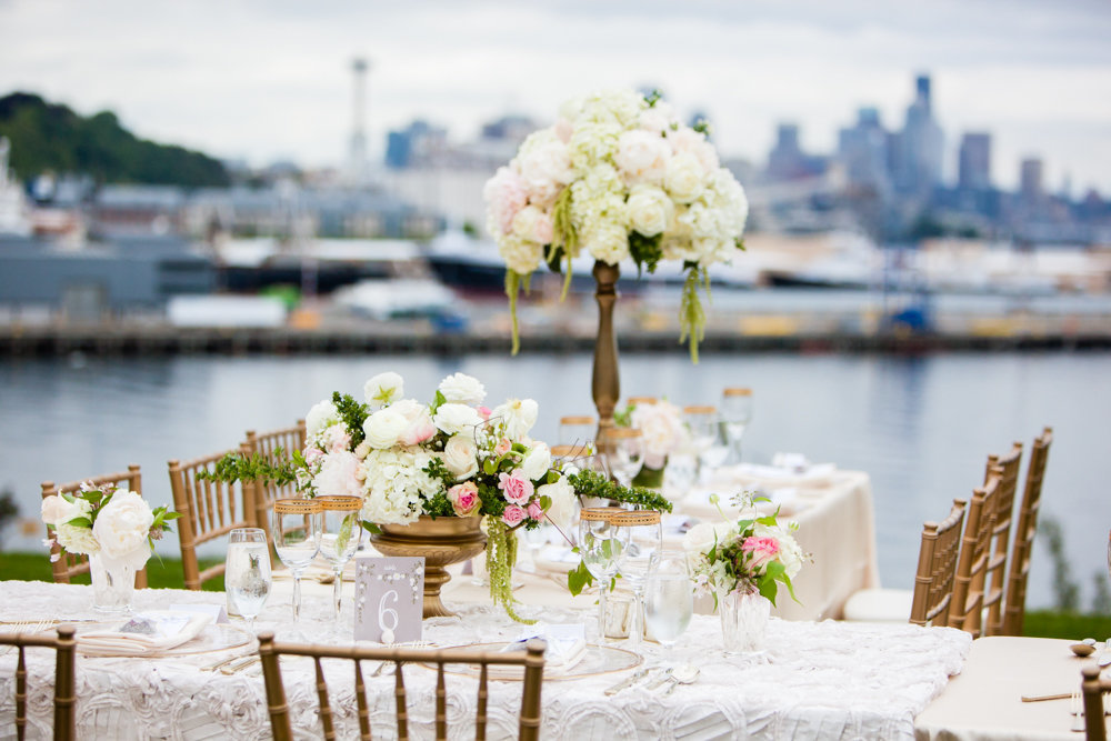 Romantic outdoor wedding reception with stunning views of Seattle featuring blush peonies.
