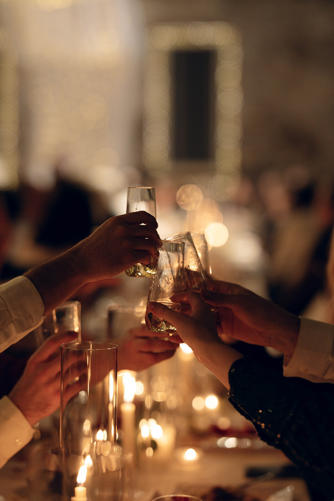 Cinematic wedding photo capturing an intimate toast moment, highlighting the elegance and warmth of an upscale wedding reception.