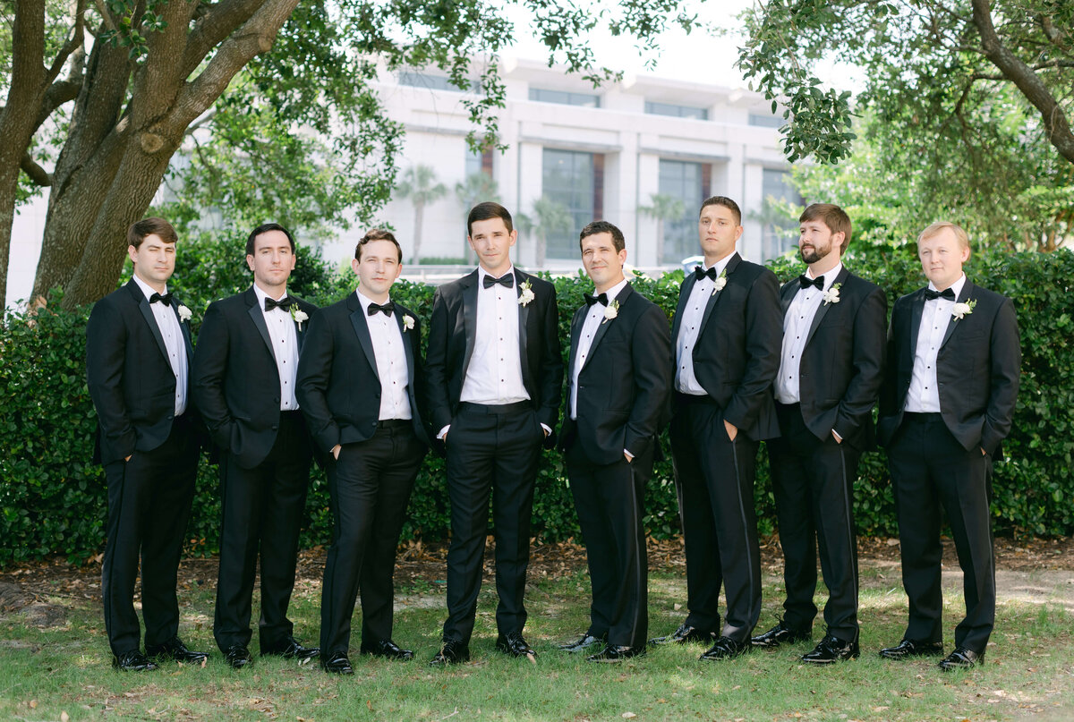 A groom stands with his groomsmen.