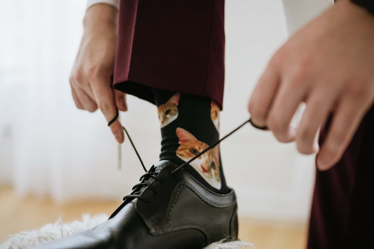 Groom fixing shoes