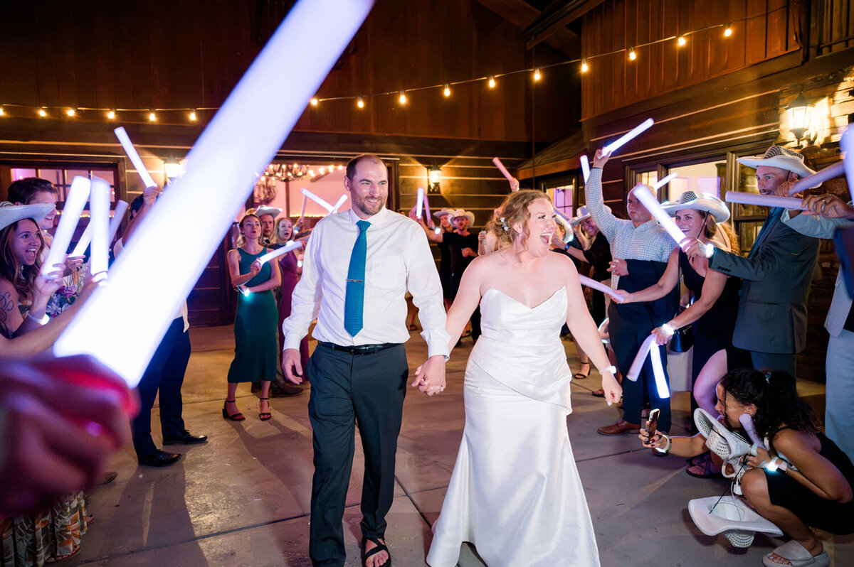 Bride and groom exiting their summer wedding reception.