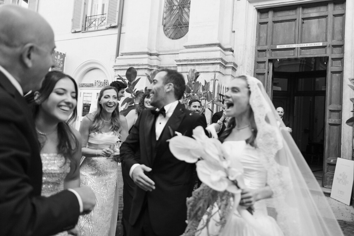 Bride and groom holding hands and smiling after wedding ceremony in Rome