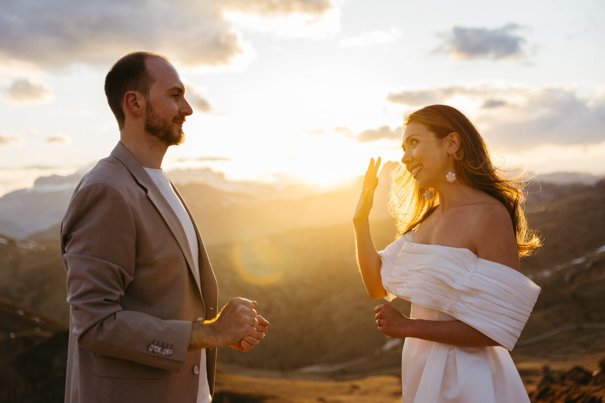 romantic couple wearing wedding ring with dramatic Dolomites backdrop