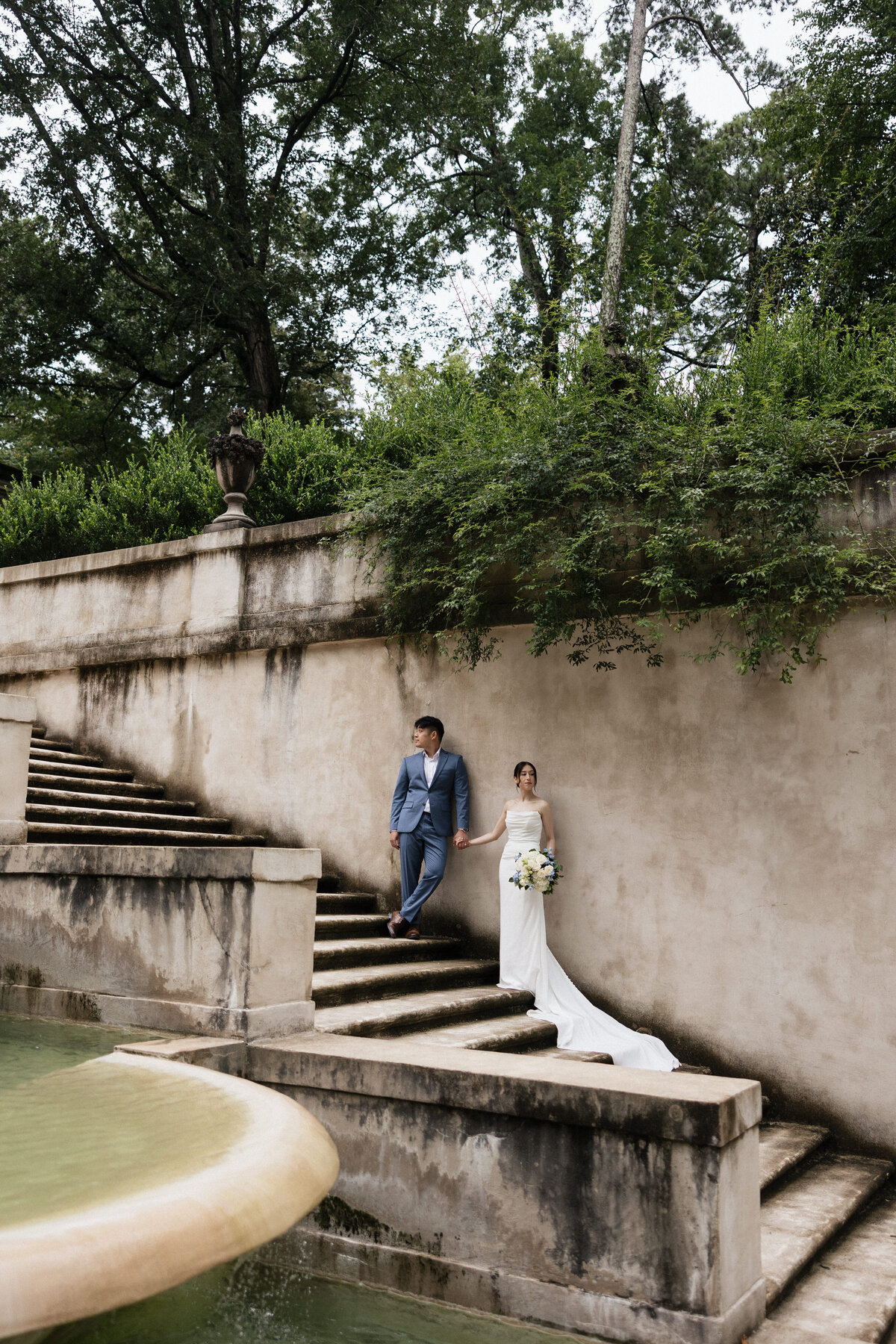 Couple on stairs posing for a photo on their wedding day.
