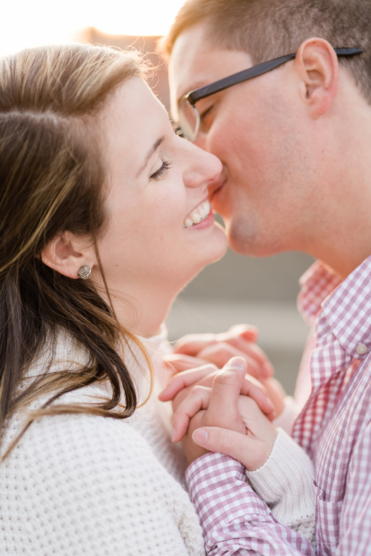 Couple smiling at each other during engagement photoshoot