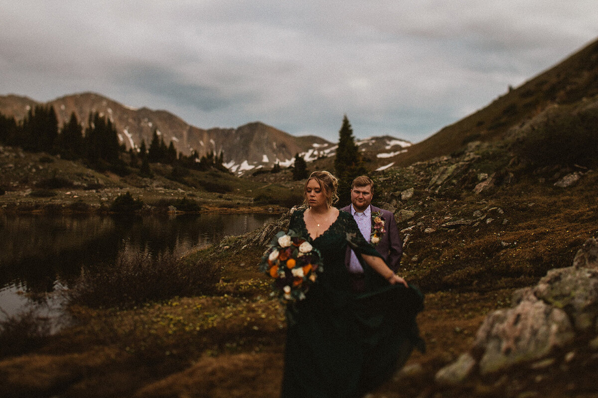 loveland pass colorado eleopement wearing green dress and purple suit