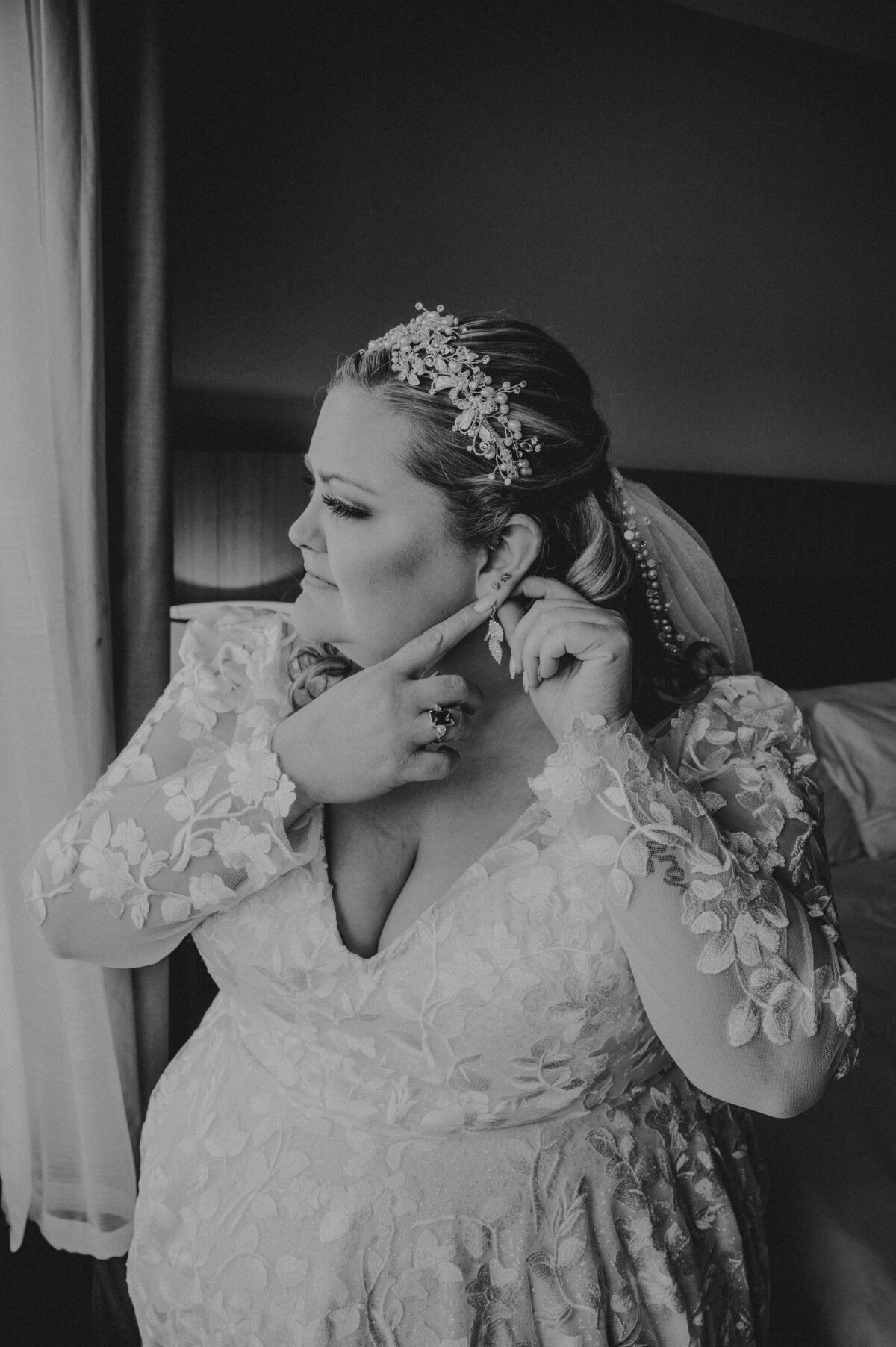Bride putting in earring