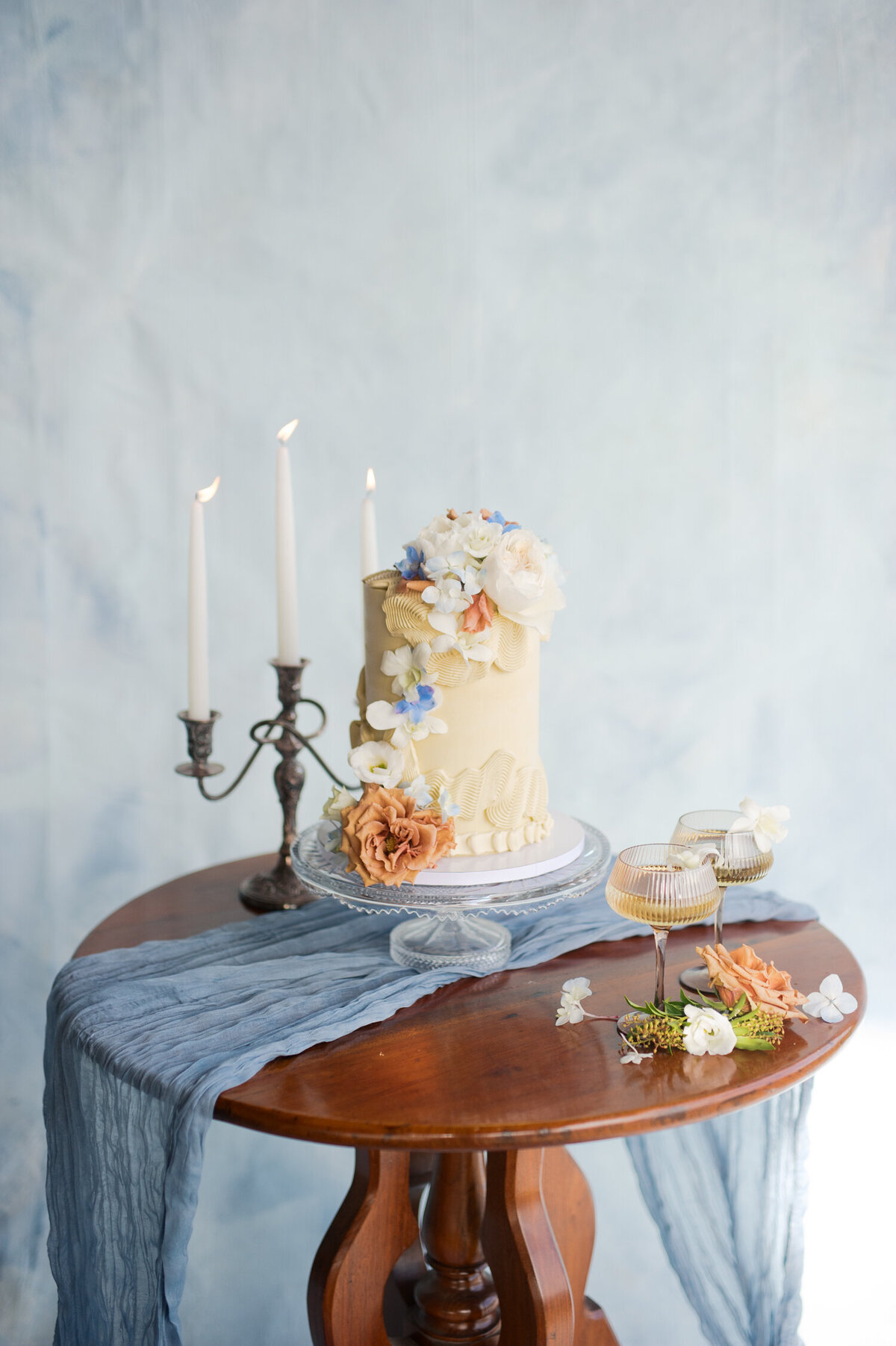 cream wedding cake with blue flowers from lux sucre desserts