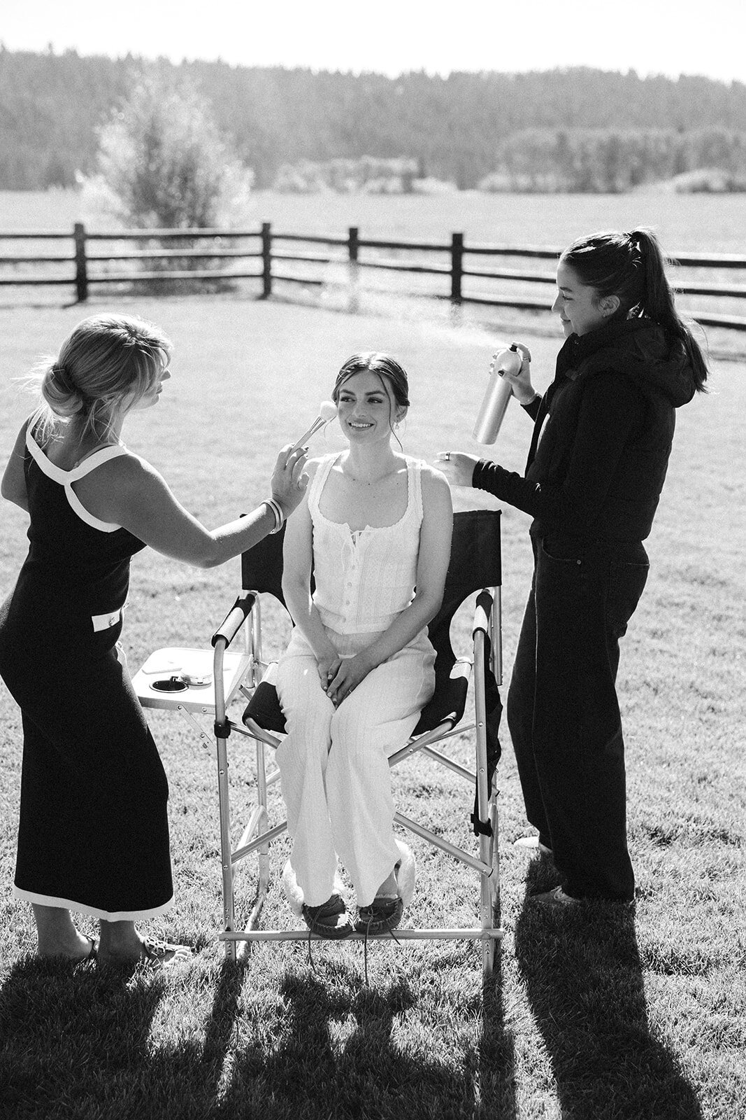 Two Jackson Hole hair and makeup artists style a bride's look outside in the wild landscapes of Wyoming