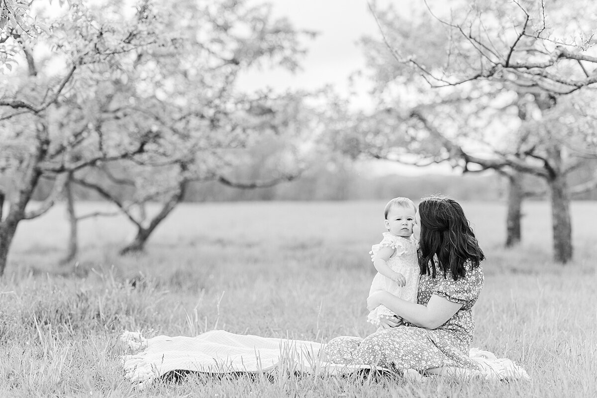 black and white of mom and daughter in apple orchard  during Family photo session with Sara Sniderman Photography in Natick Massachusetts