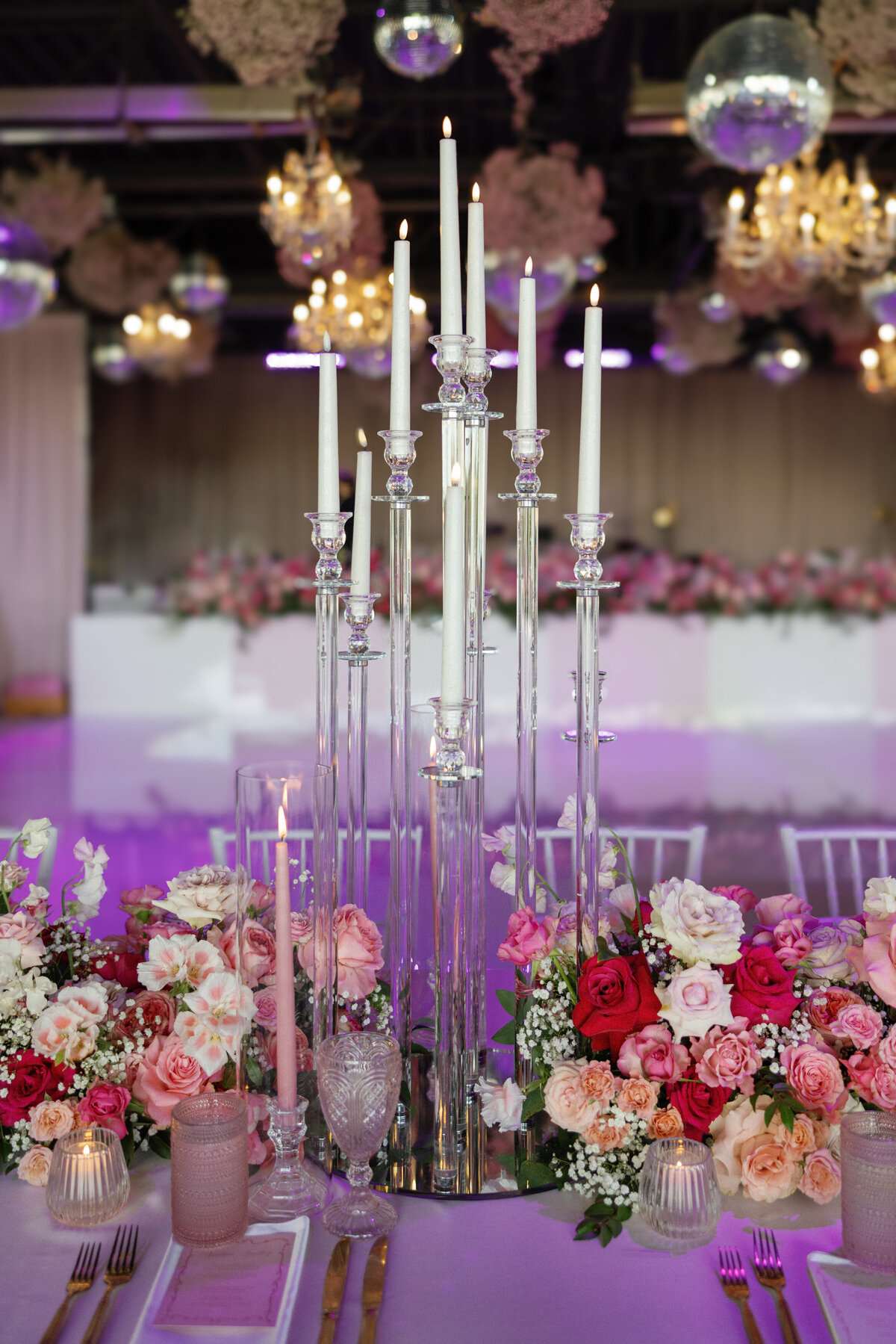 pink table at wedding reception with tall candles