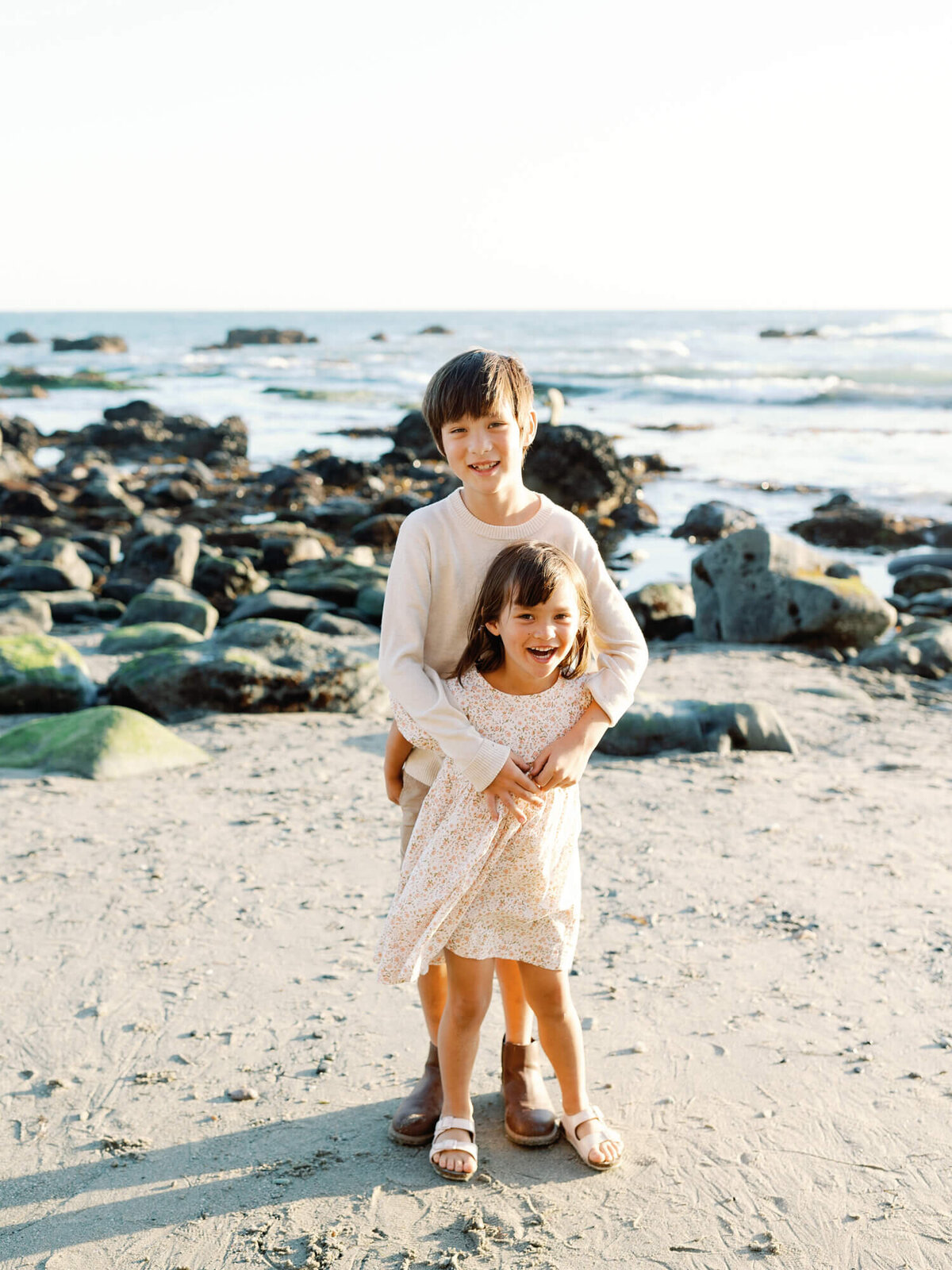 photo of brother and sister looking at the beach