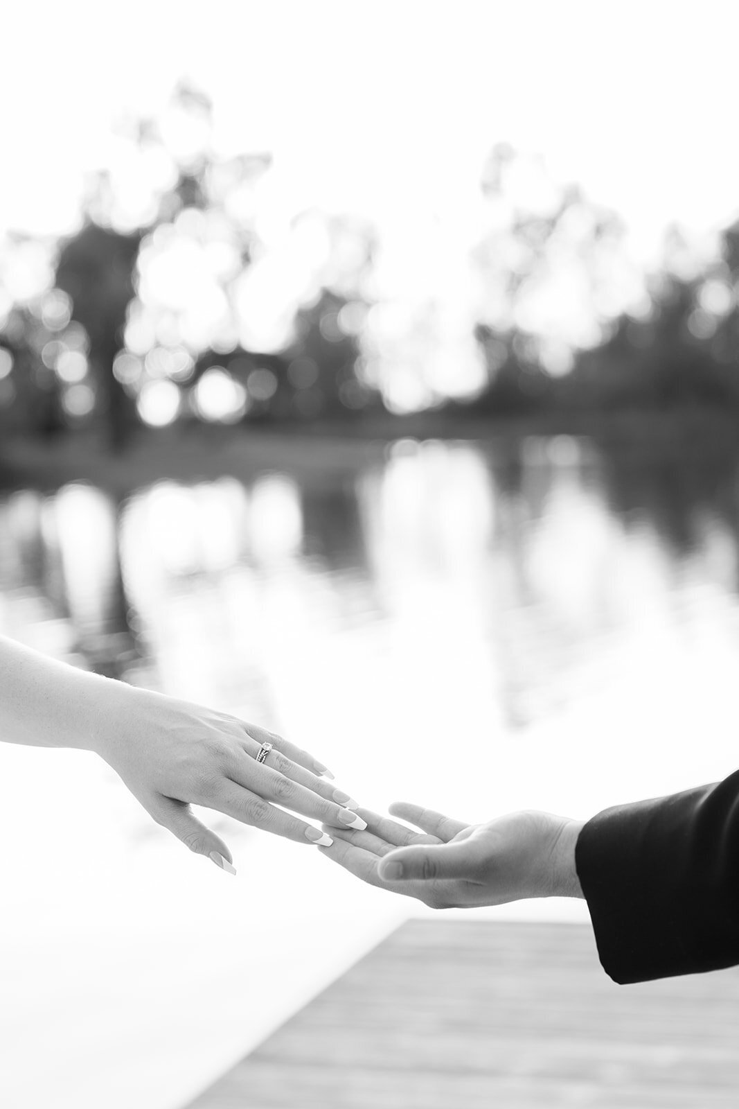 Couple gently touches hands at the dock