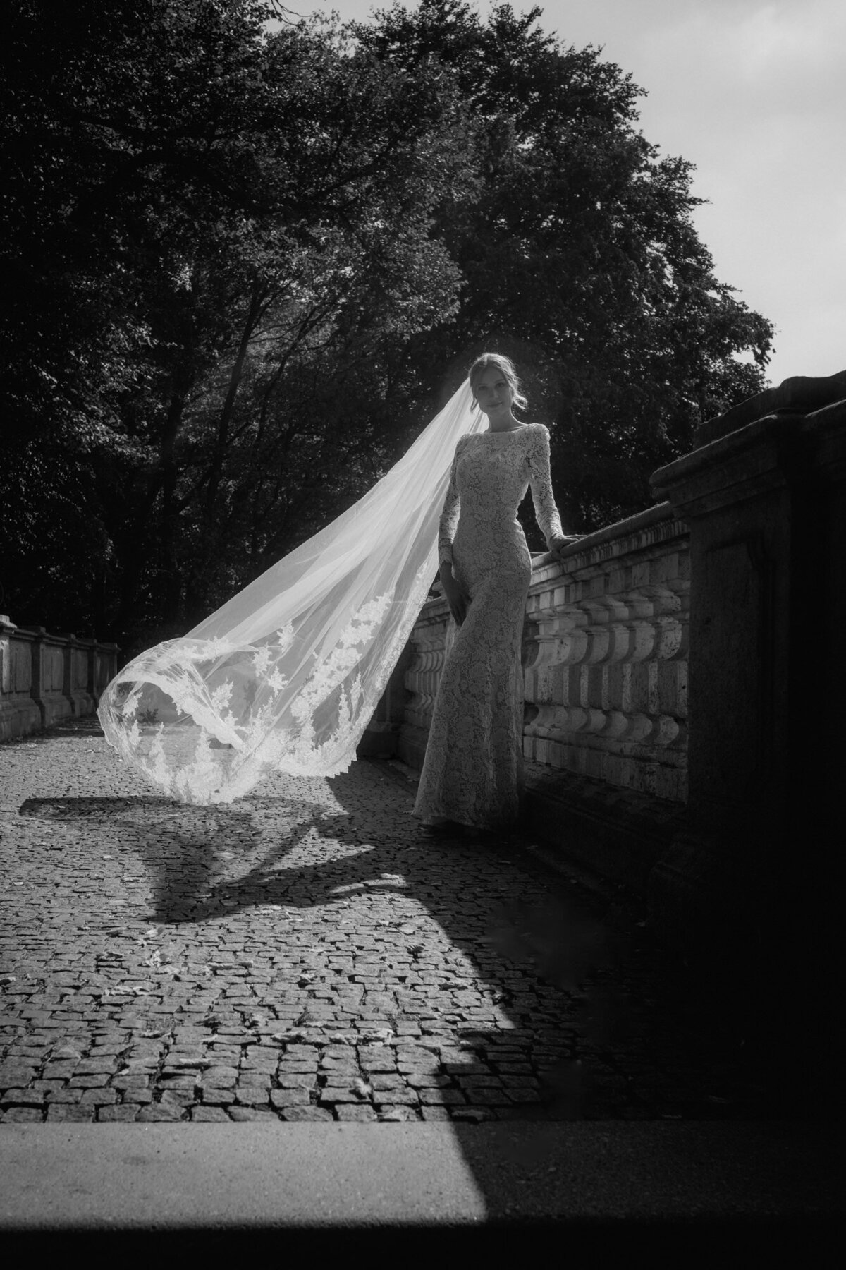 Bridal photography with long veil flying in the wind.