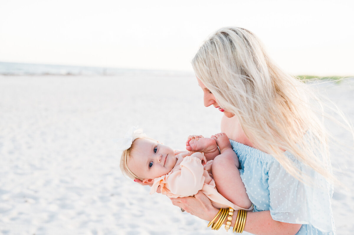 mom holding baby at Navarre Beach