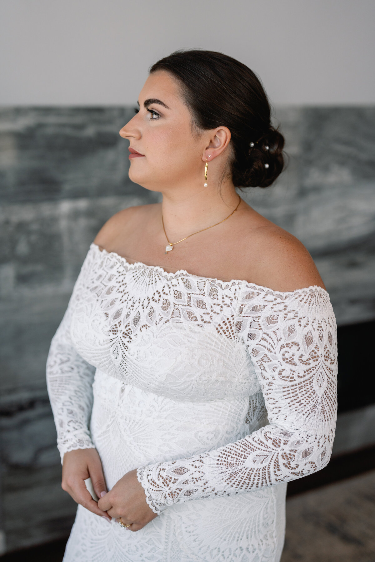 Bridal portrait in a lace gown with off the shoulder sleeves