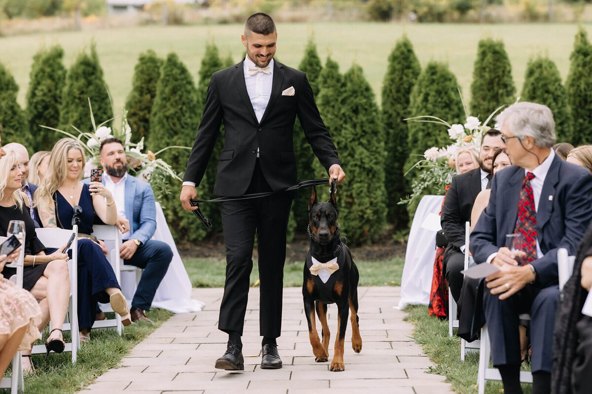 Groomsmen with dog walking down the aisle at Finger Lakes Wedding