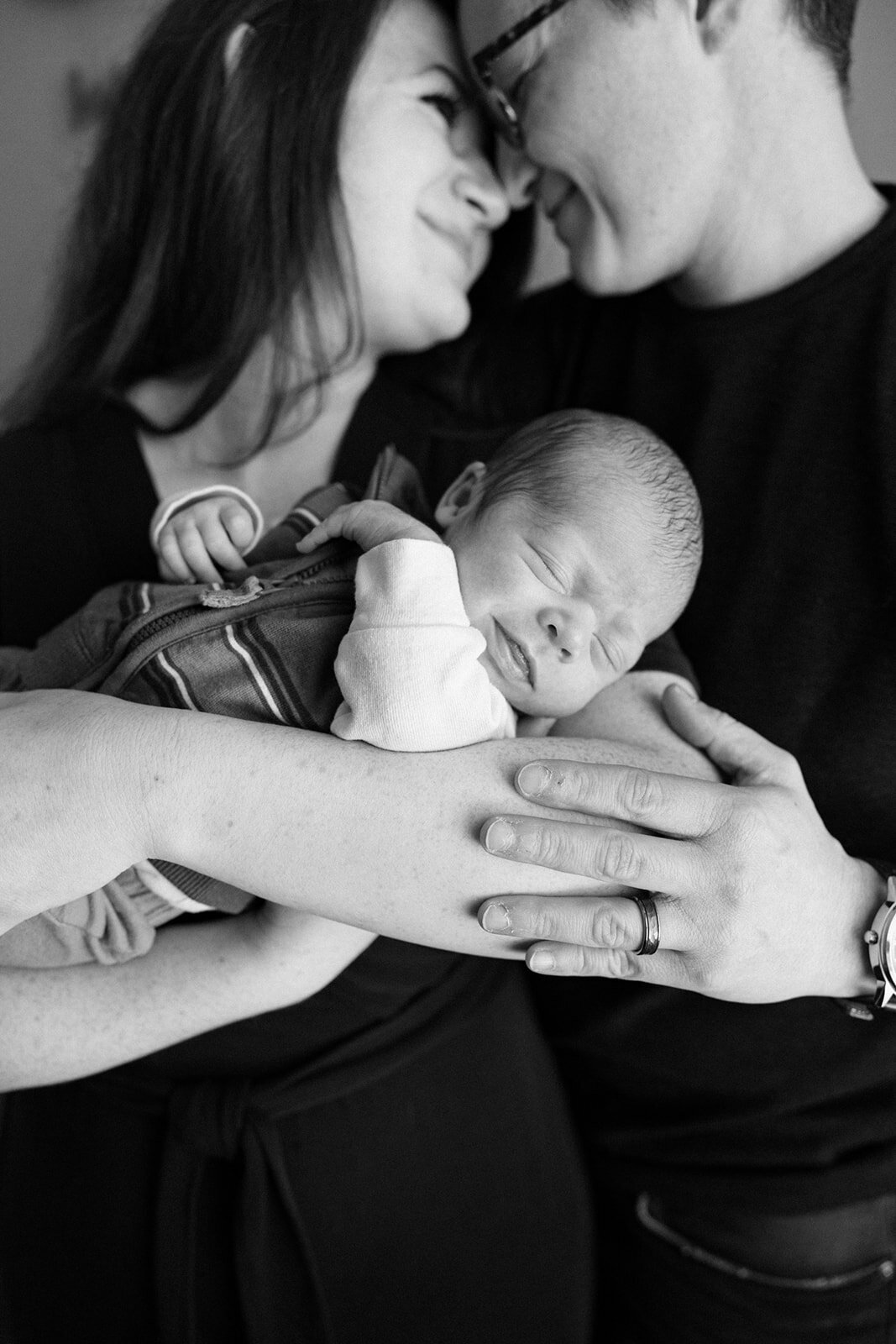 Couple holding their newborn for their at home session