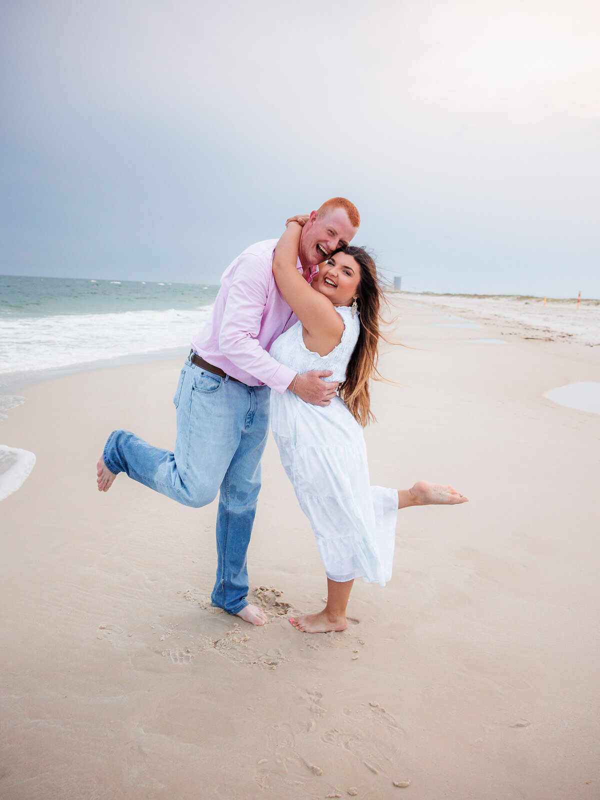 authentic moment as couple kicks feet in the sand with laughter