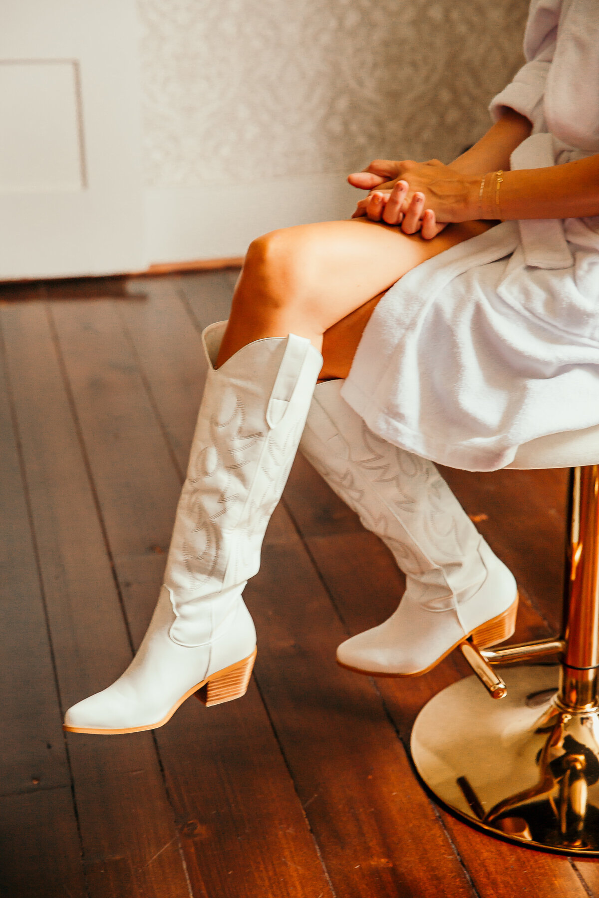 close up of bride's white cowboy boots