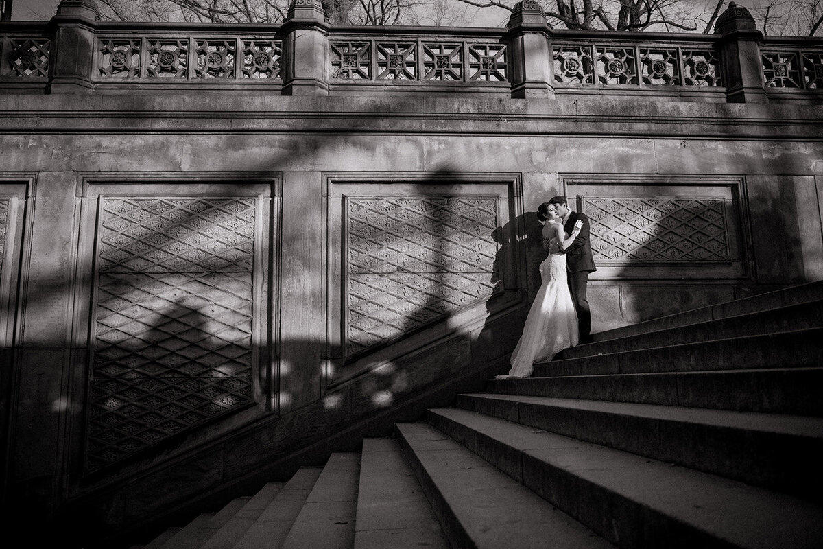 bride and groom in sunlight on steps for central park wedding photo by Cait Fletcher Photography
