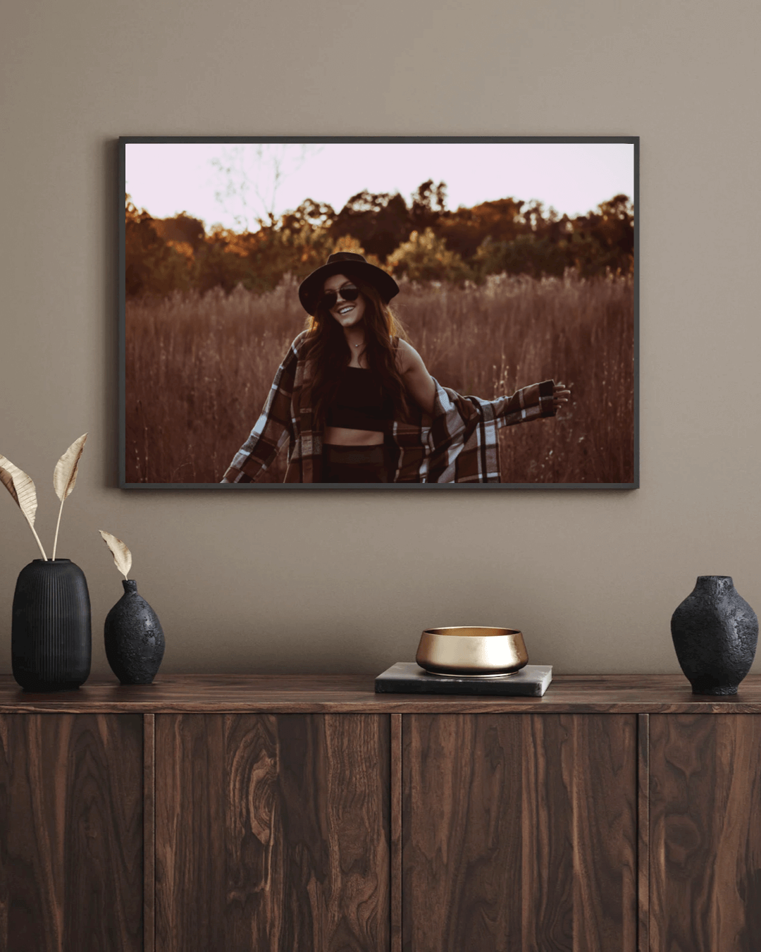 entry way desk with framed senior photography on the wall
