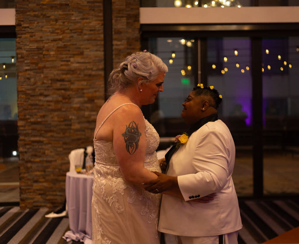 A newlywed couple dancing together.