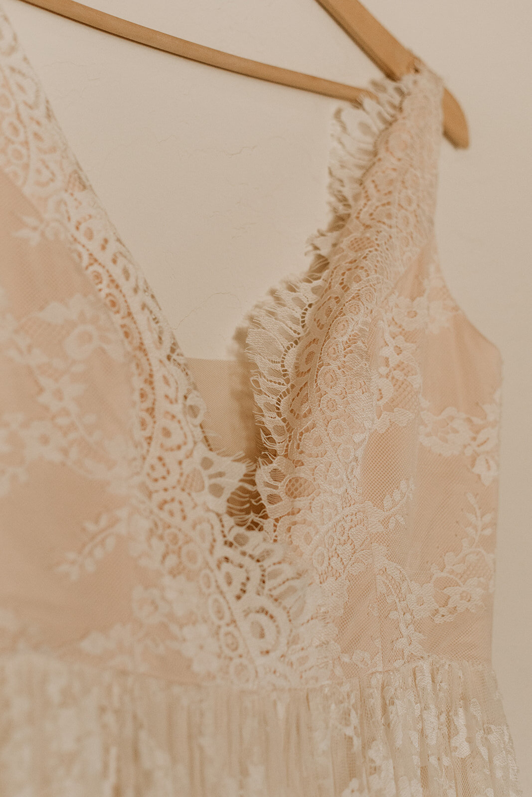 close up of delicate pink lace wedding dress