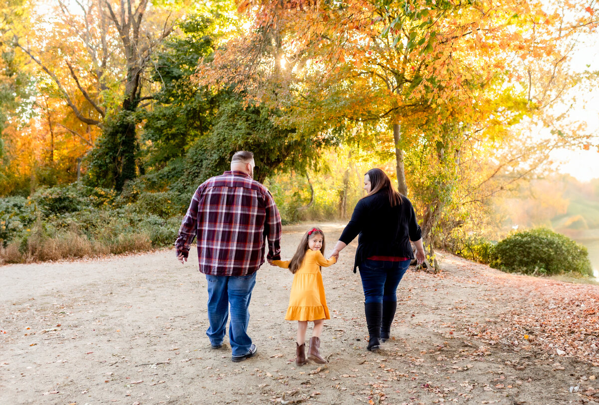 A family taking a stroll on a nature path in a park
