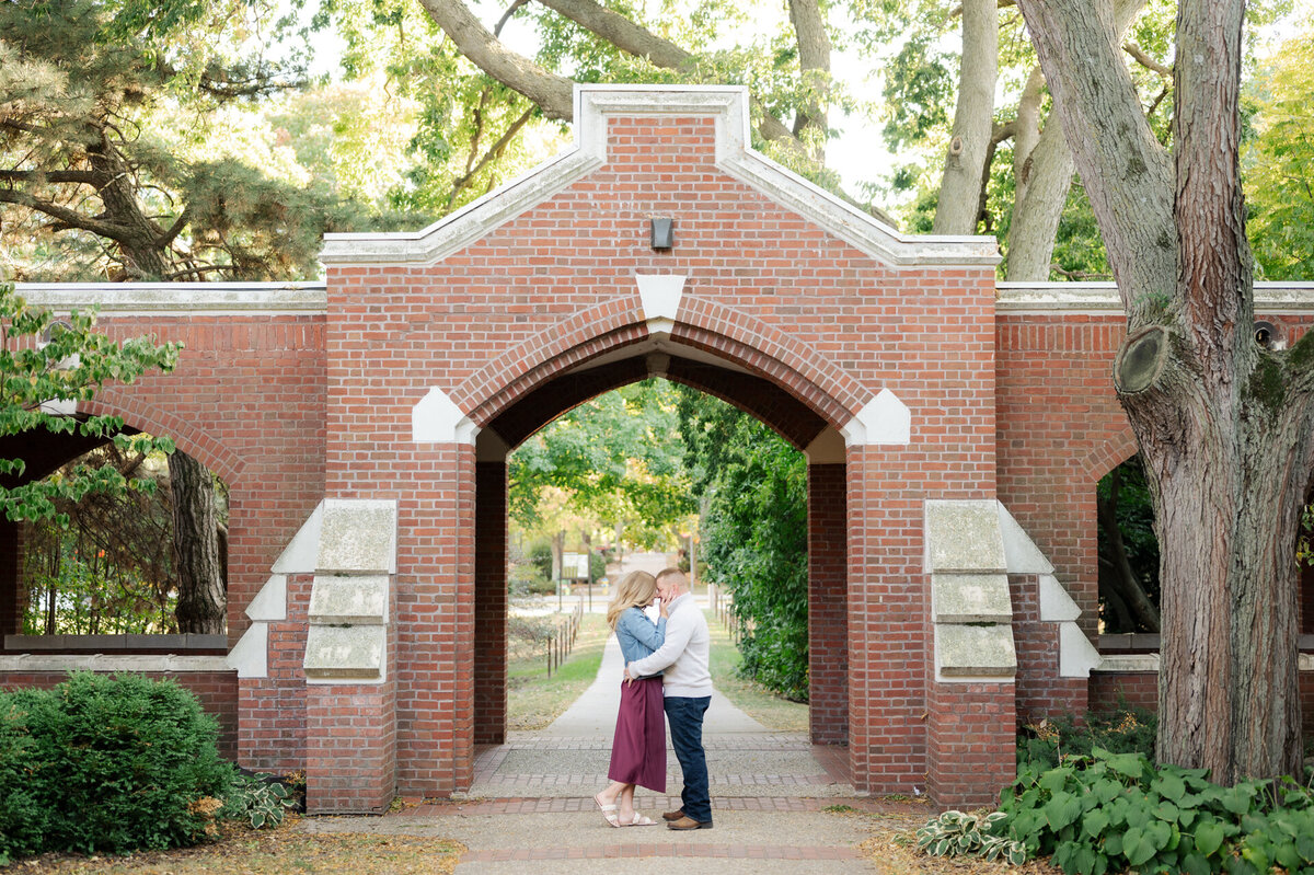 couple holds one another under archway