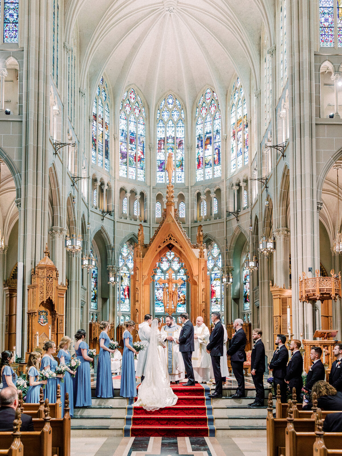Bride, groom, and bridal party stand at altar during Cathedral Basilica of the Assumption wedding in Covington, KY