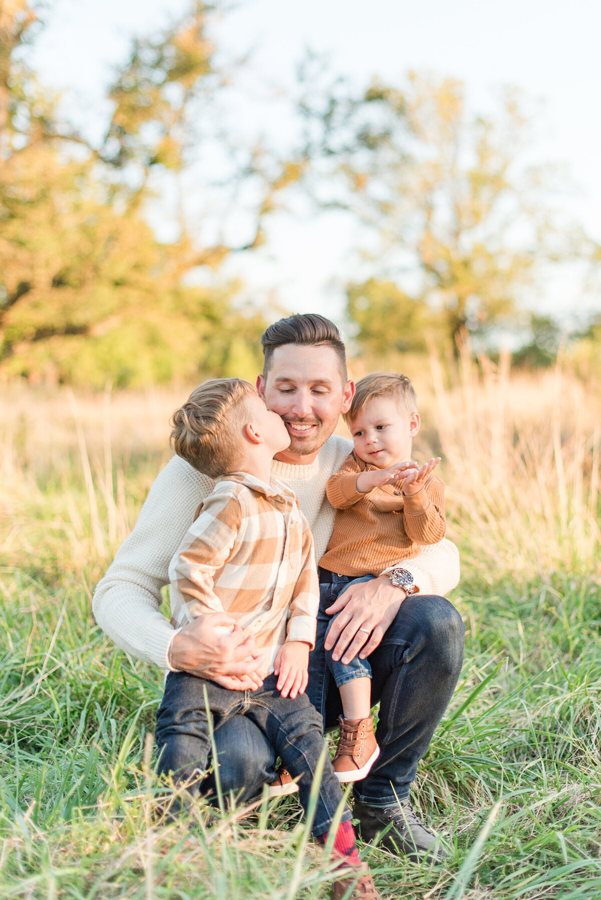 dad and kids kissing tan fall outfits