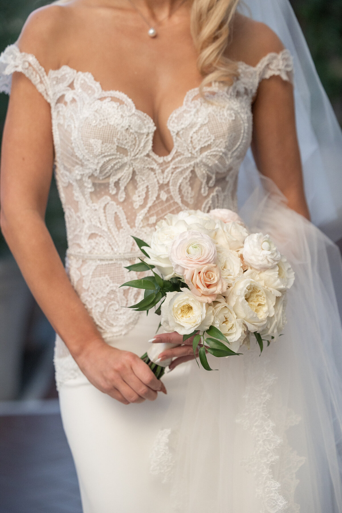 Close up of a bride holding a bouquet of flowers