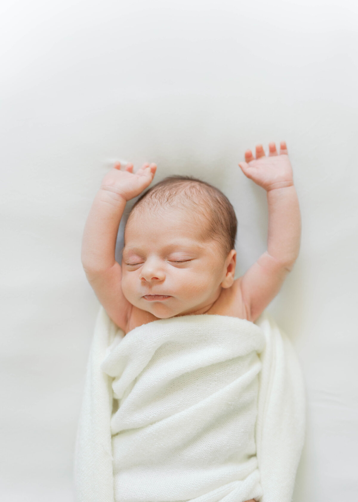 newborn baby stretching and sleeping in virginia beach newborn photography session