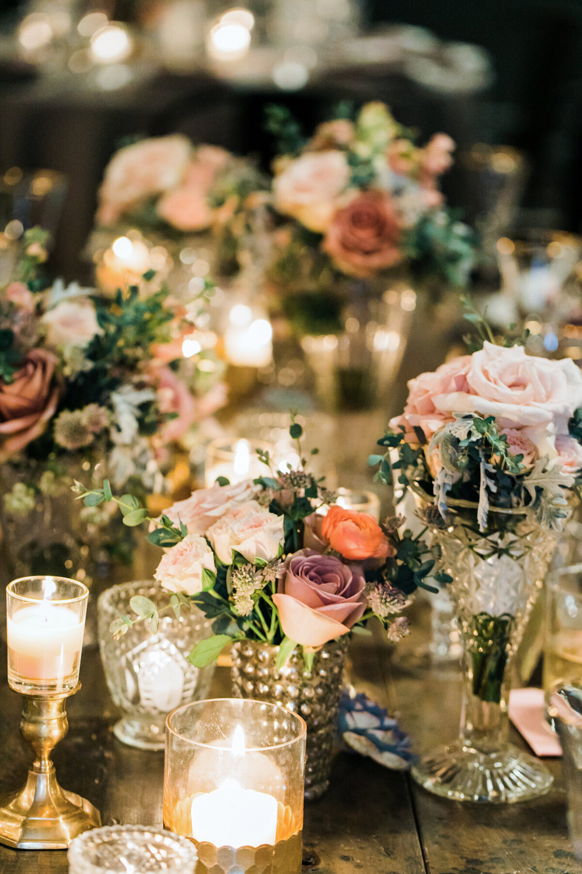 A closeup photo of the flowers and candles at a wedding reception at Artifact Events in Chicago