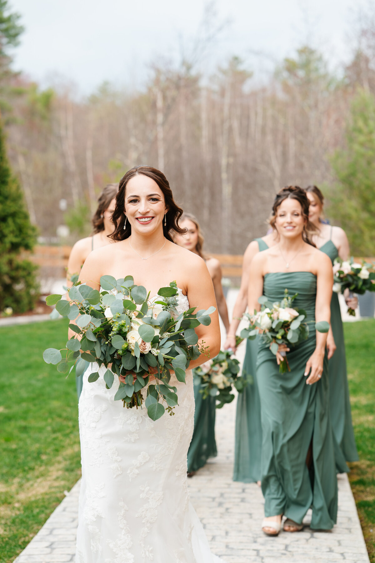 Bride and groom walking hand in hand at their outdoor New England wedding