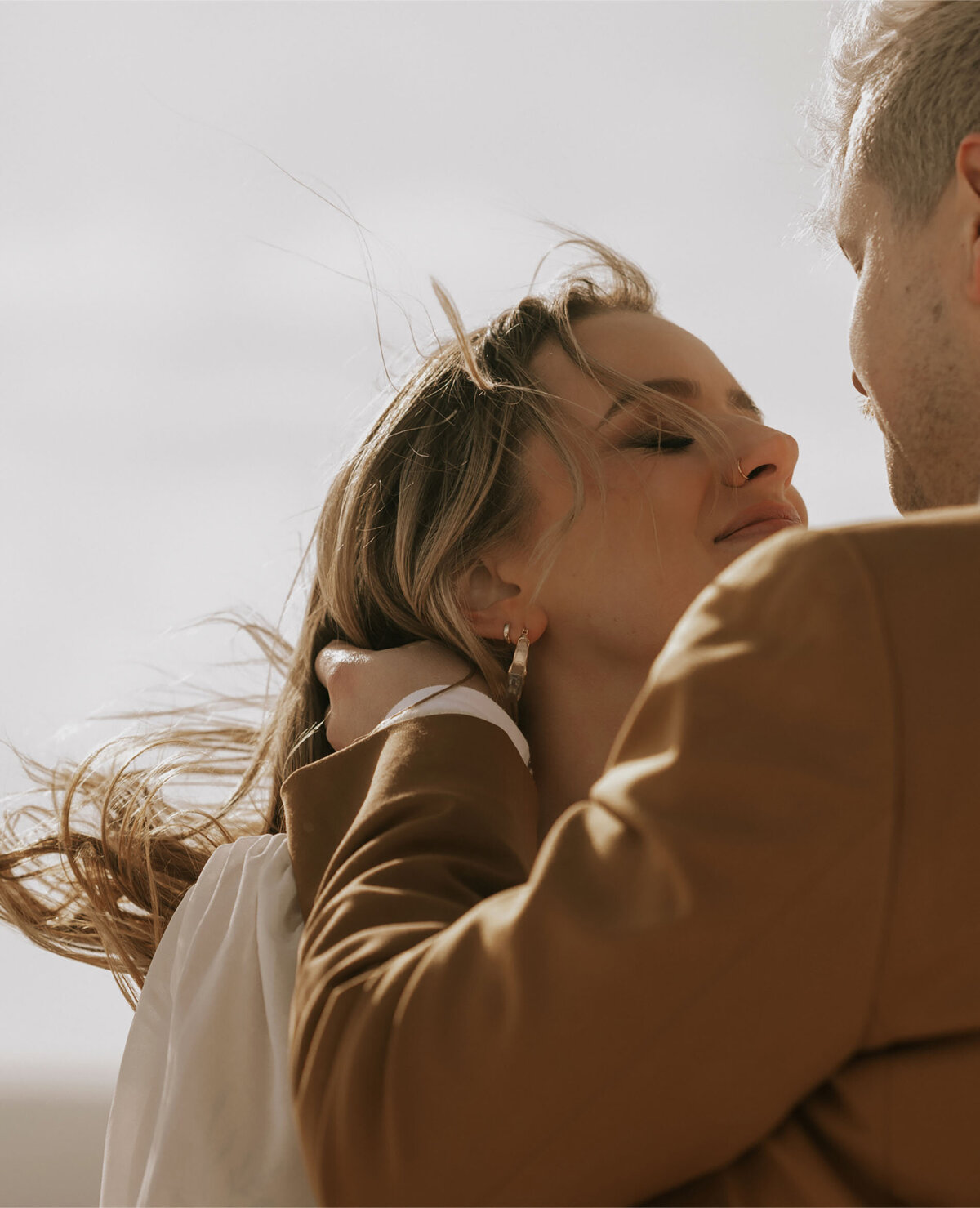 groom gently touching bride's face during private elopement on snowy day in Bend, Oregon