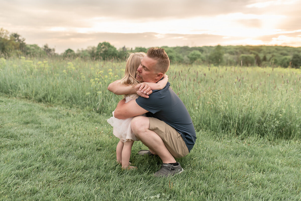 Dad hugging daughter in field at sunset |Sharon Leger Photography | Canton, CT Newborn & Family Photographer