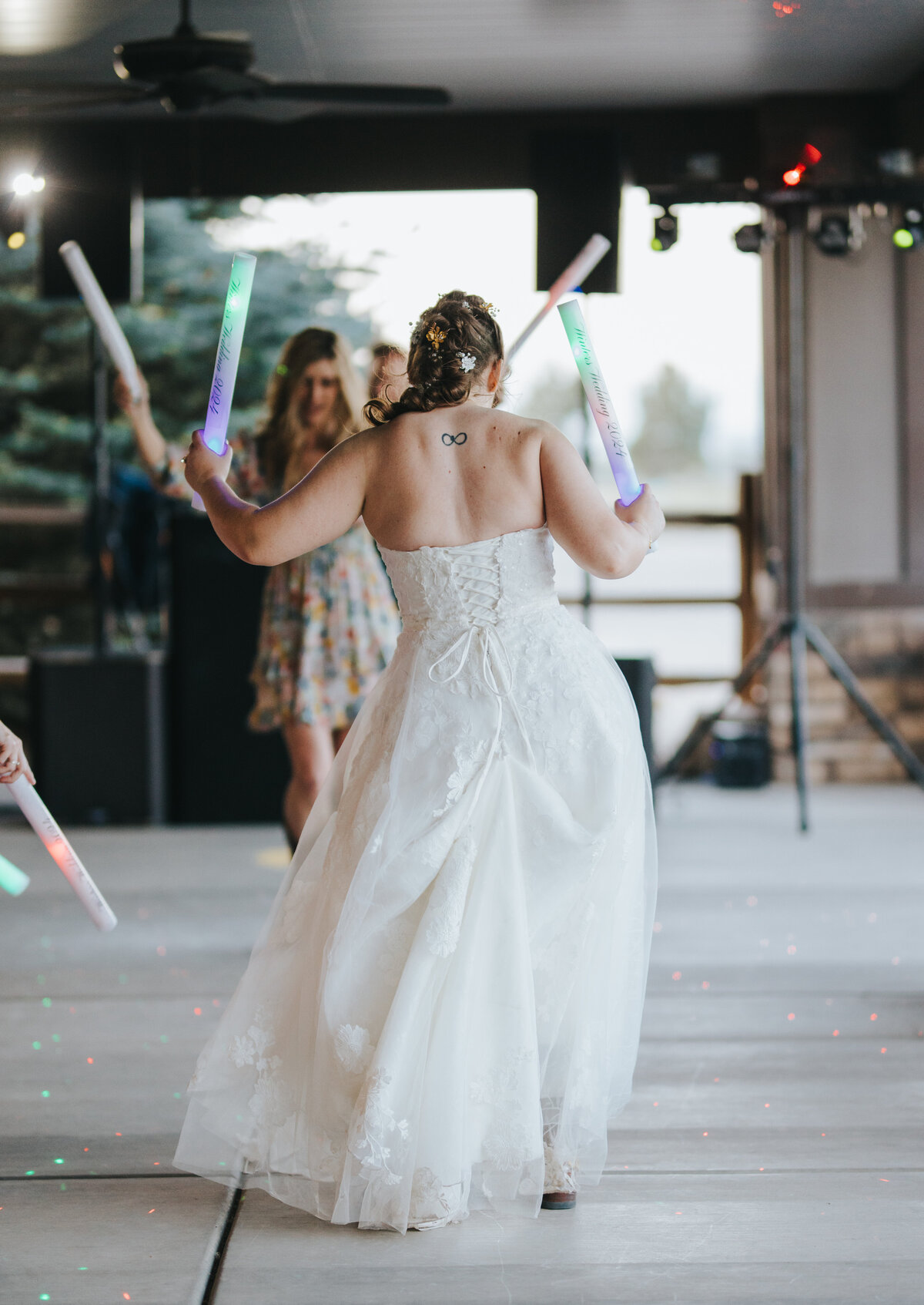 Bride dancing with glow sticks at the reception