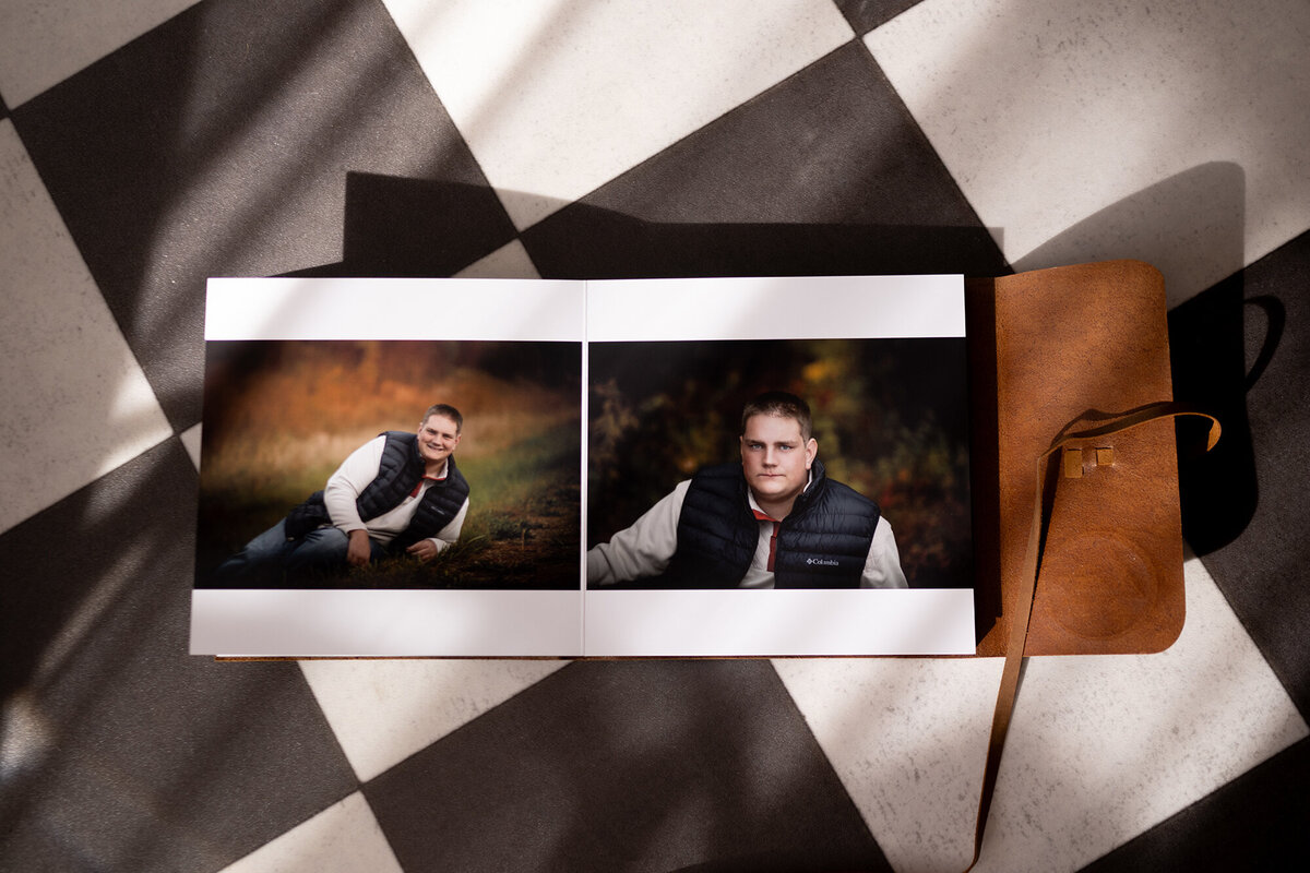 A photo album lays open to two photos with leather binding