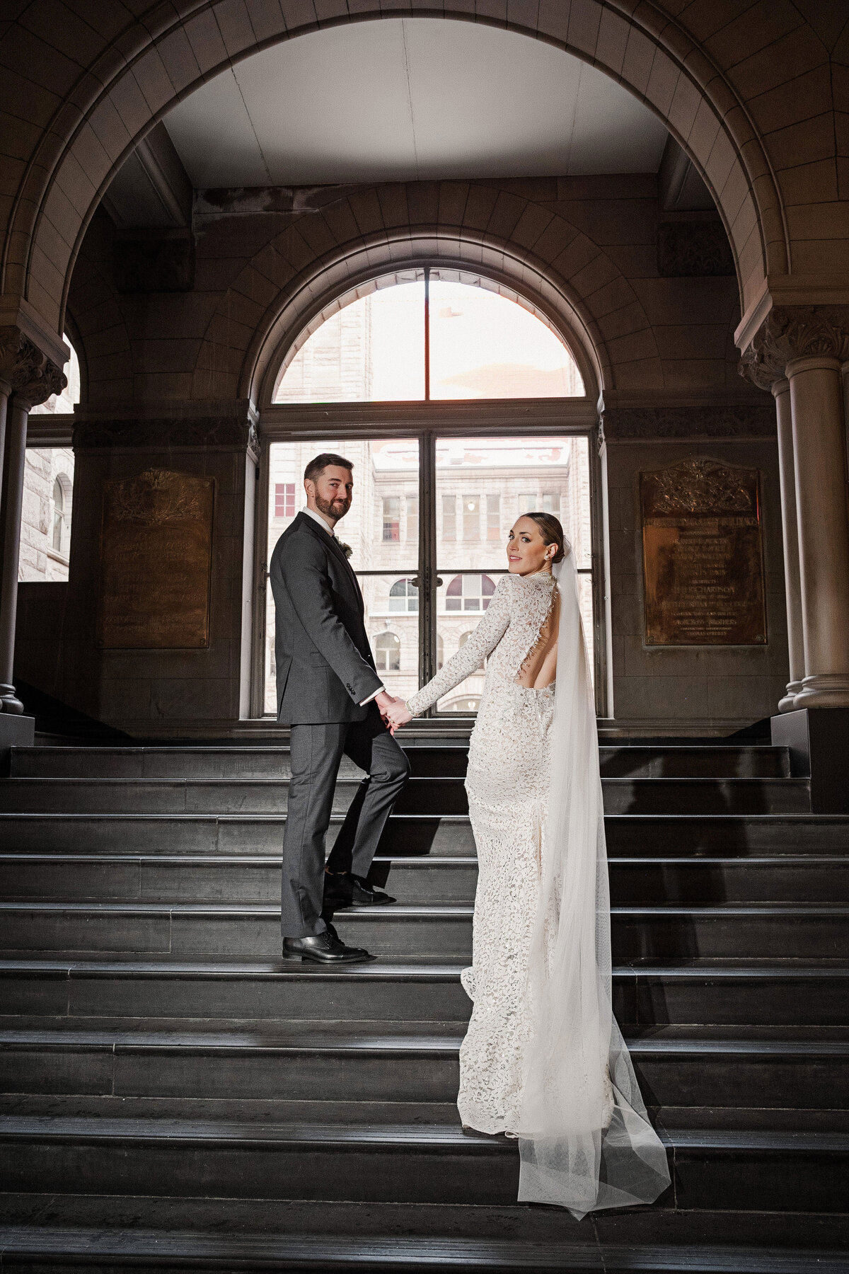 bride and groom on staircase of allegheny county courthouse pittsbrugh