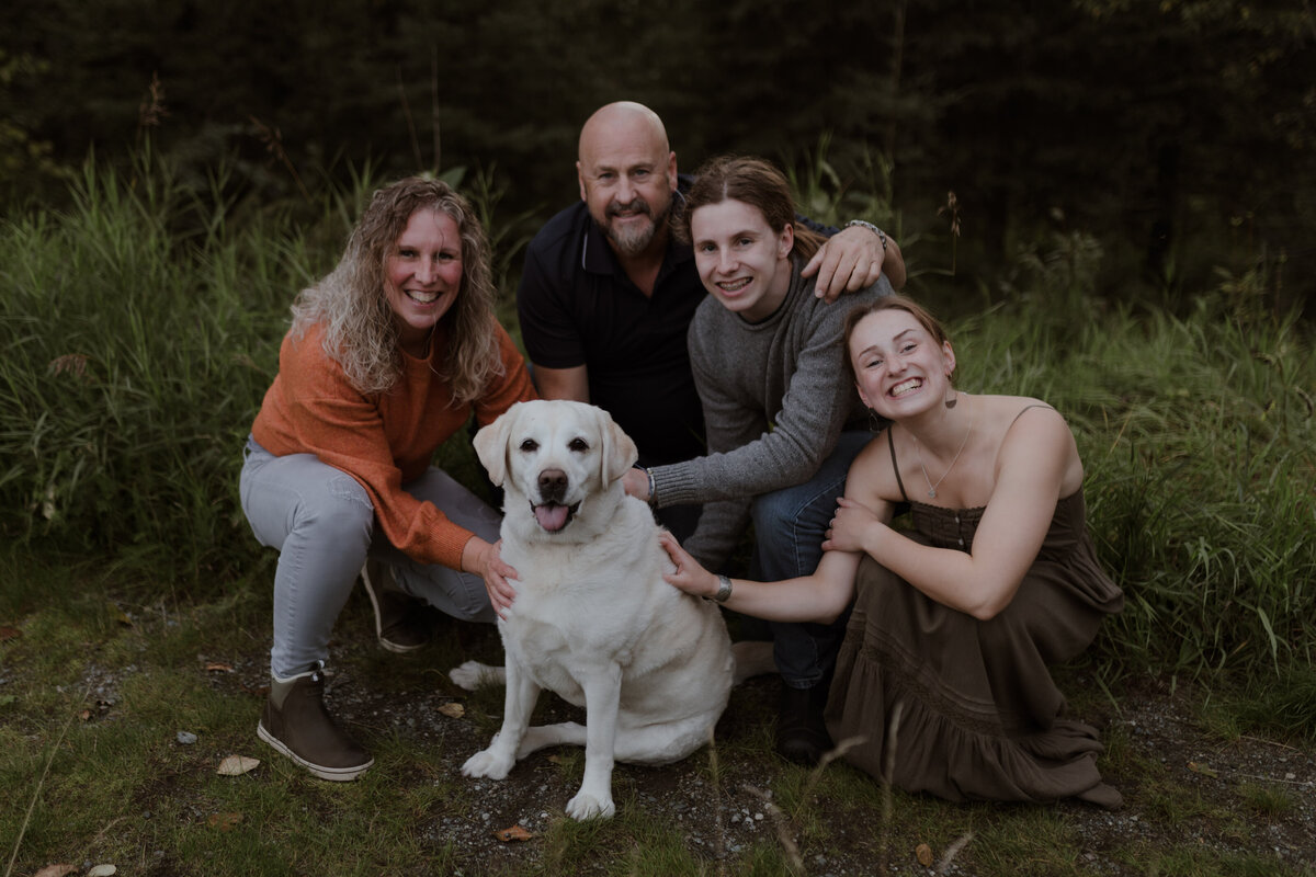 Family posing with dog