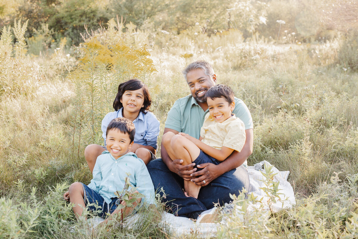 A dad sits for a nice portrait during his family session in Guelph.