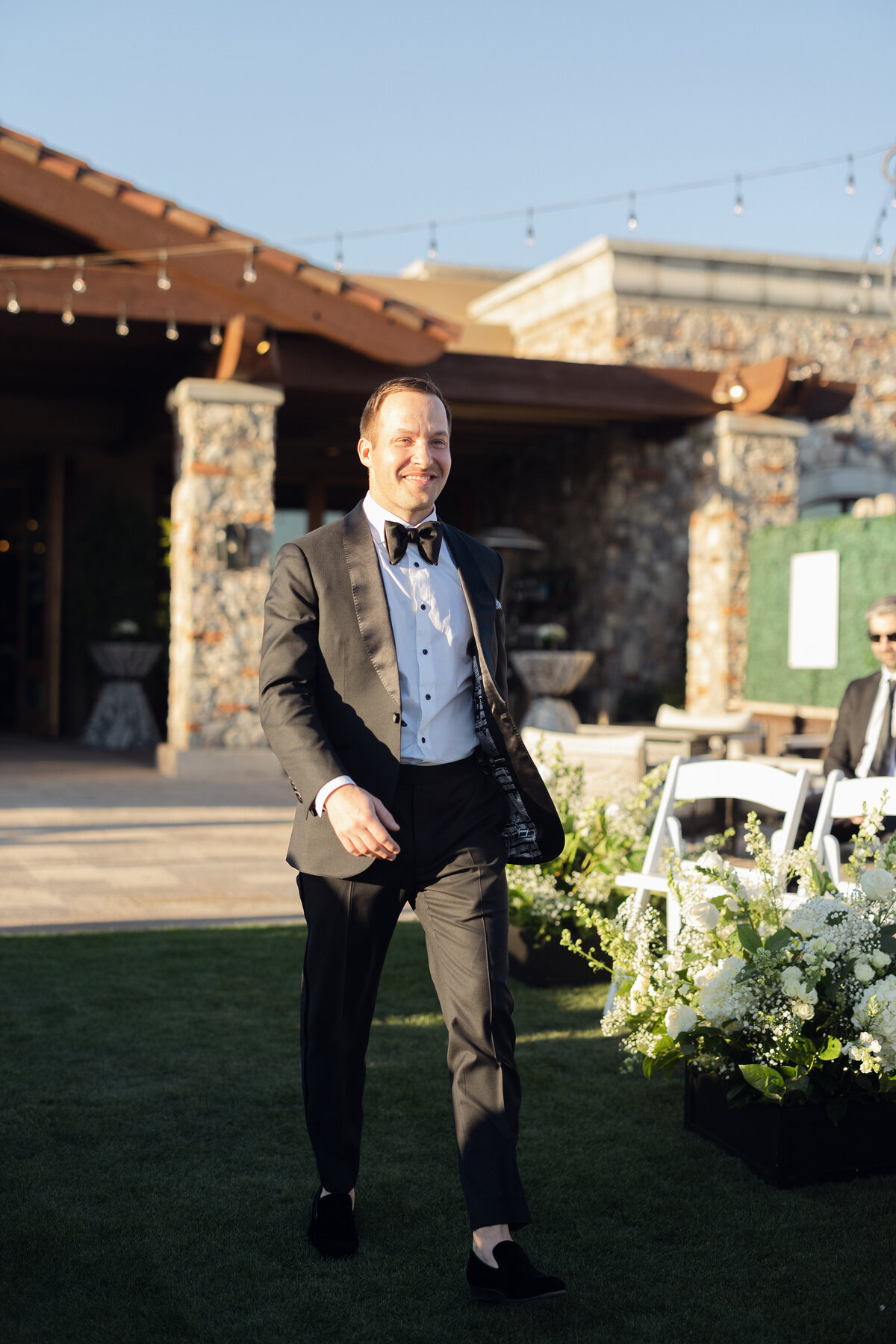 Groom walking down aisle at wedding ceremony